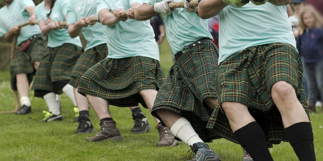Kilted men playing Highland Games activities