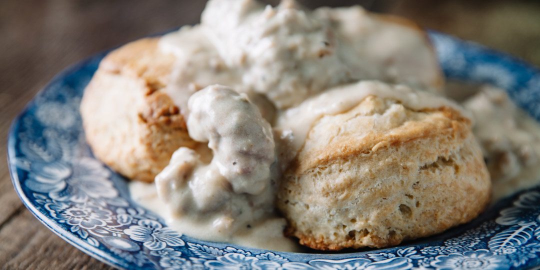 Biscuits and gravy on blue plate