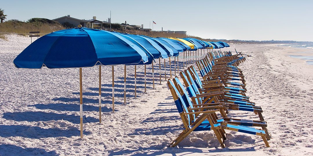 line of chairs and umbrellas on beach